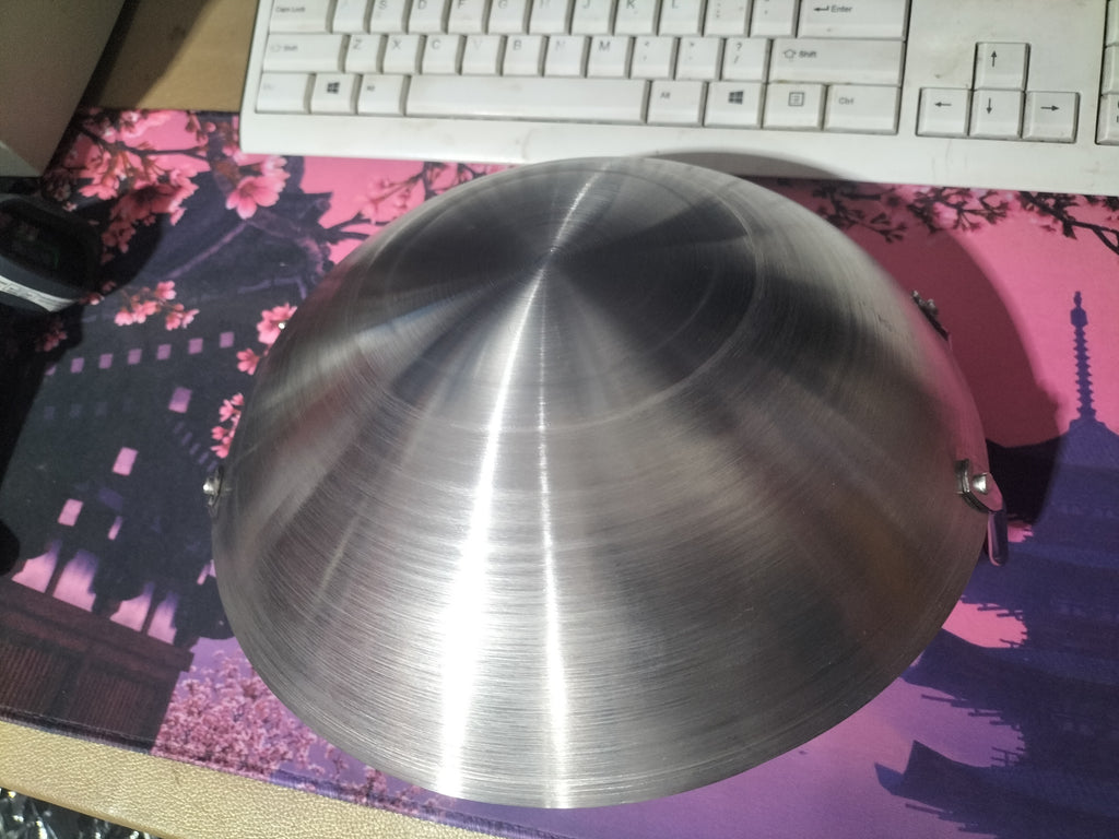 Metallic bowl on a pink and purple mouse pad with a keyboard in the background