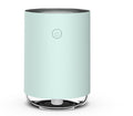Mint green air purifier on a white background