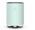Mint green air purifier on a white background