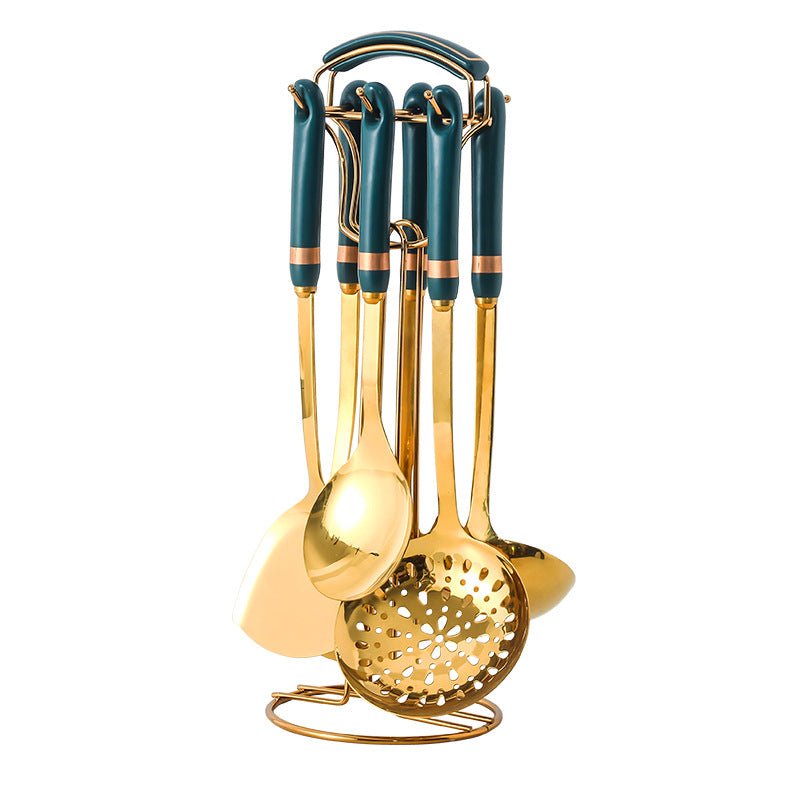 Set of gold kitchen utensils with green handles on a white background