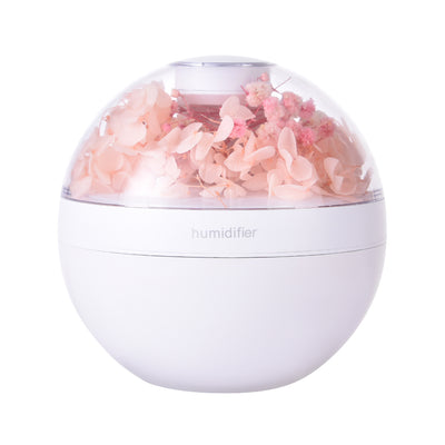 Creative Silent Air Humidifier in pink with soft mist on a desk