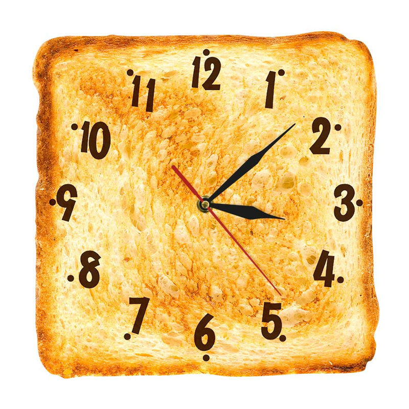 Square clock made to look like a piece of toast with black numbers and hands on a white background