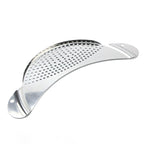 Metallic kitchen tool with perforated design on a white background