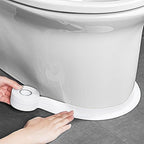 Person applying a white rubber seal strip to a toilet base.